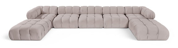 Light gray modular sectional sofa with tufted cushions and rounded armrests