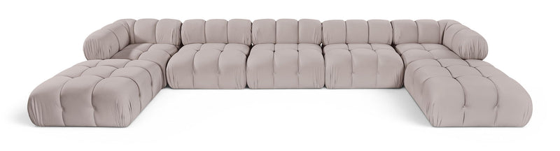 Light gray modular sectional sofa with tufted cushions and rounded armrests