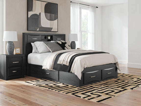Black queen bed with bookcase headboard and storage drawers beneath, styled with bedding