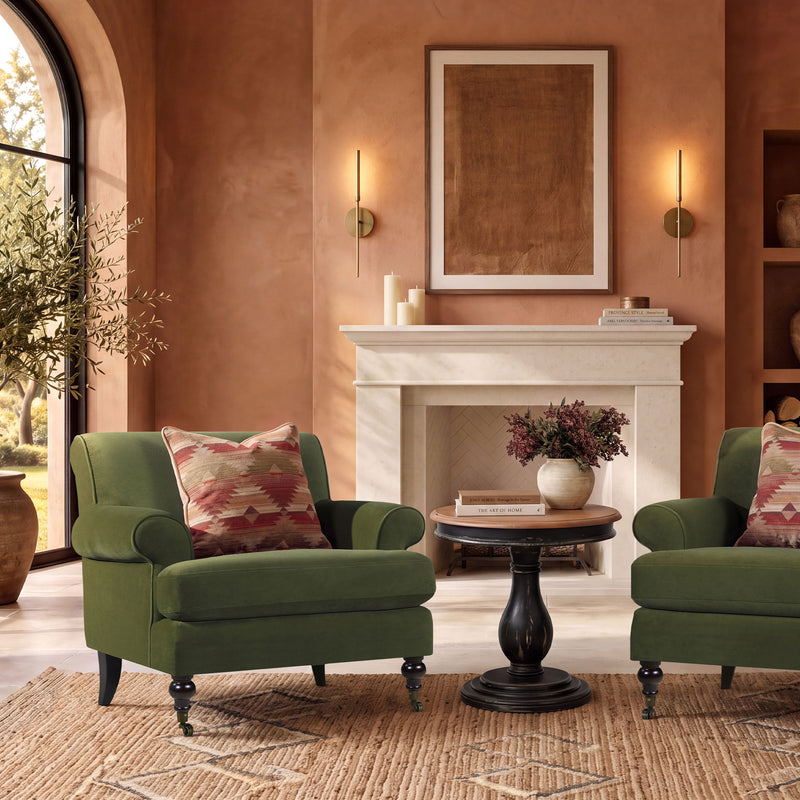 Dark green accent armchair with rolled arms, casters, and square seat cushion