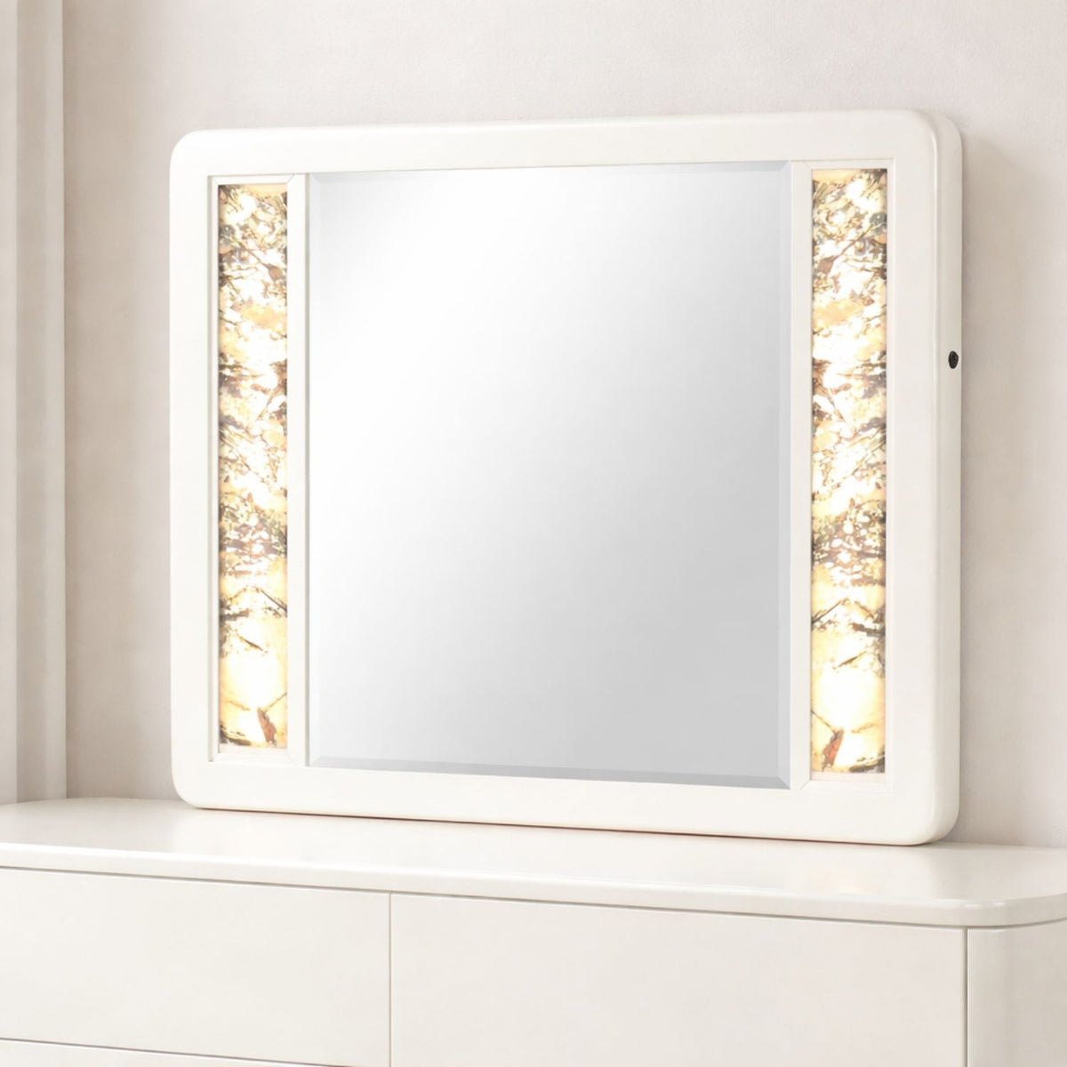 Beige rectangular LED mirror with glowing side panels and small control knob on frame.
