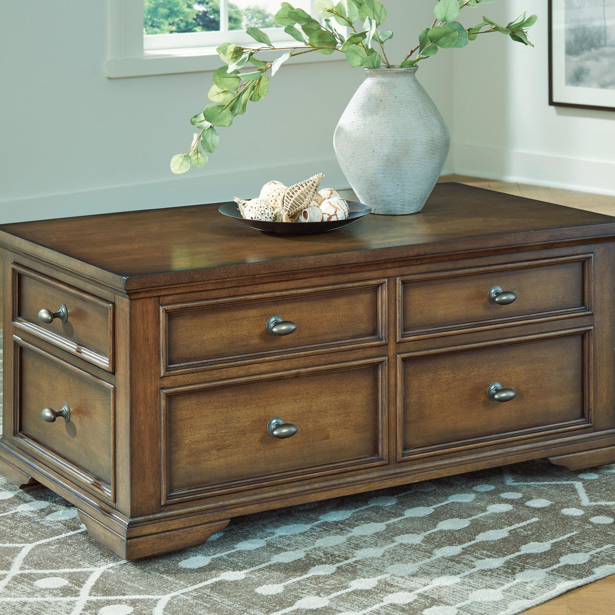 Dark brown wood cocktail table with four drawers and metal pulls, flat square top