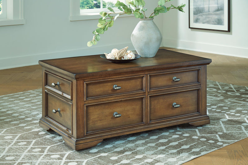 Dark brown wood cocktail table with four drawers and metal pulls, flat square top