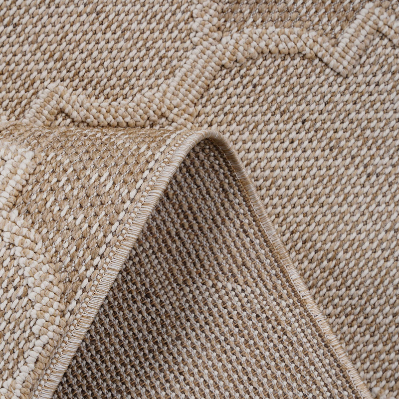 Beige trellis rug corner detail with braided edge and short fringe tassels