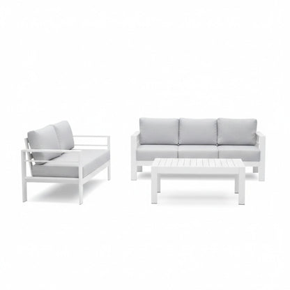 Outdoor patio seating set with white frames and gray cushions, loveseat and coffee table