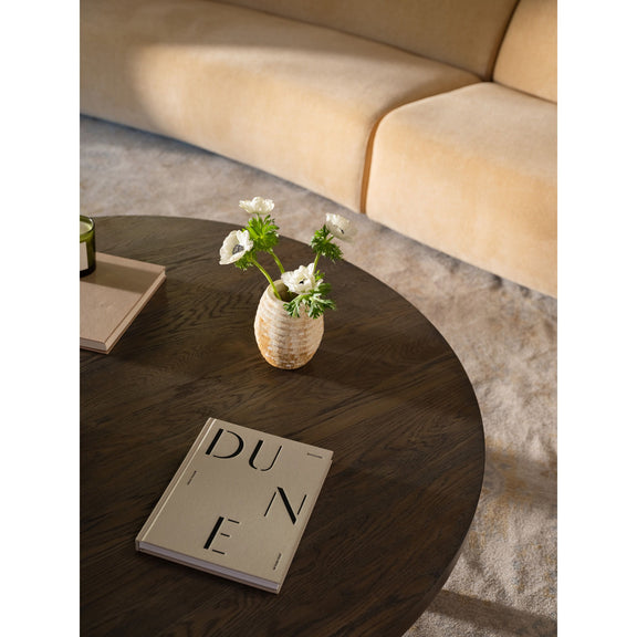 Round dark brown coffee table with wood top and sturdy angled legs