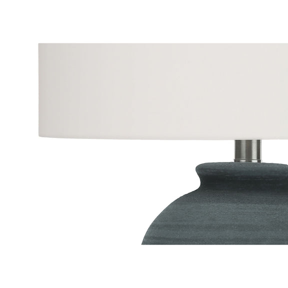 White drum shade and dark blue ceramic lamp base with metal neck