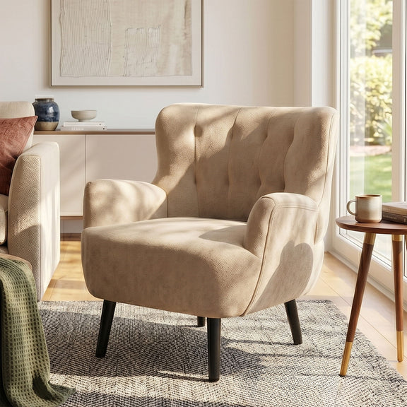 Tan upholstered armchair with round arms, tufted back, wide seat, black legs