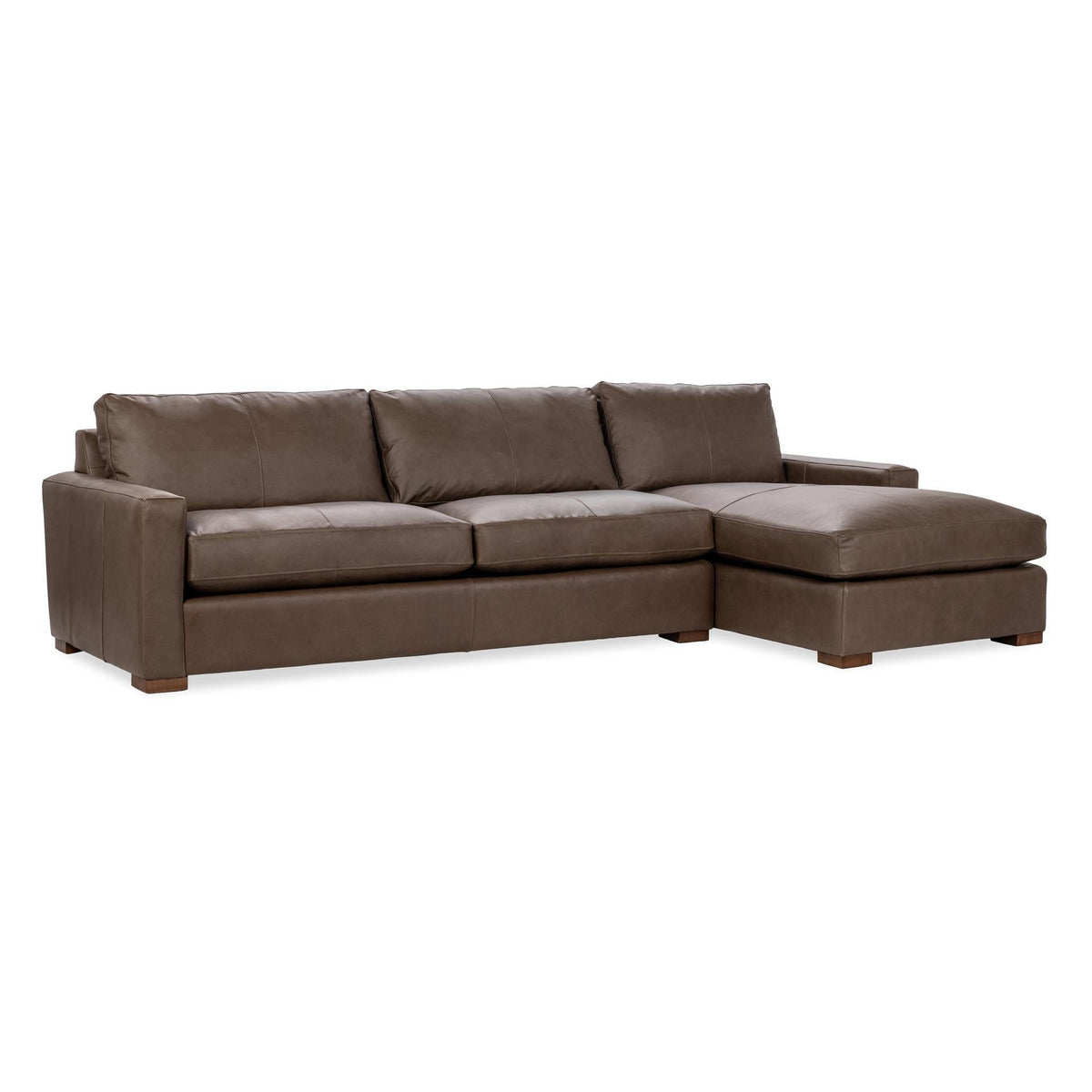 Chaise sofa in medium brown with tufted back cushions and chaise ottoman seat