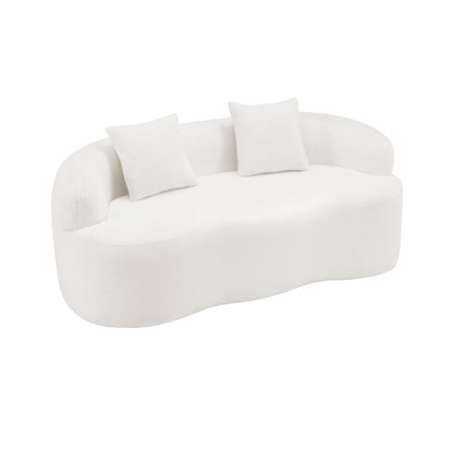 White curved loveseat sofa with round armrests and two square throw pillows