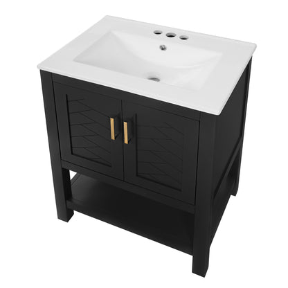 Black bathroom vanity cabinet with white sink top, double doors, and gold vertical handles
