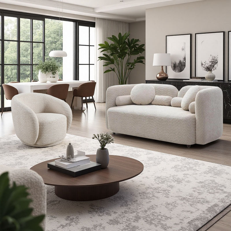 Beige upholstered sofa with rounded arms and two matching accent chairs