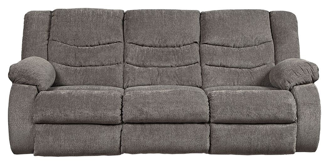 Gray reclining sofa with three seat cushions, padded arms, and three back sections