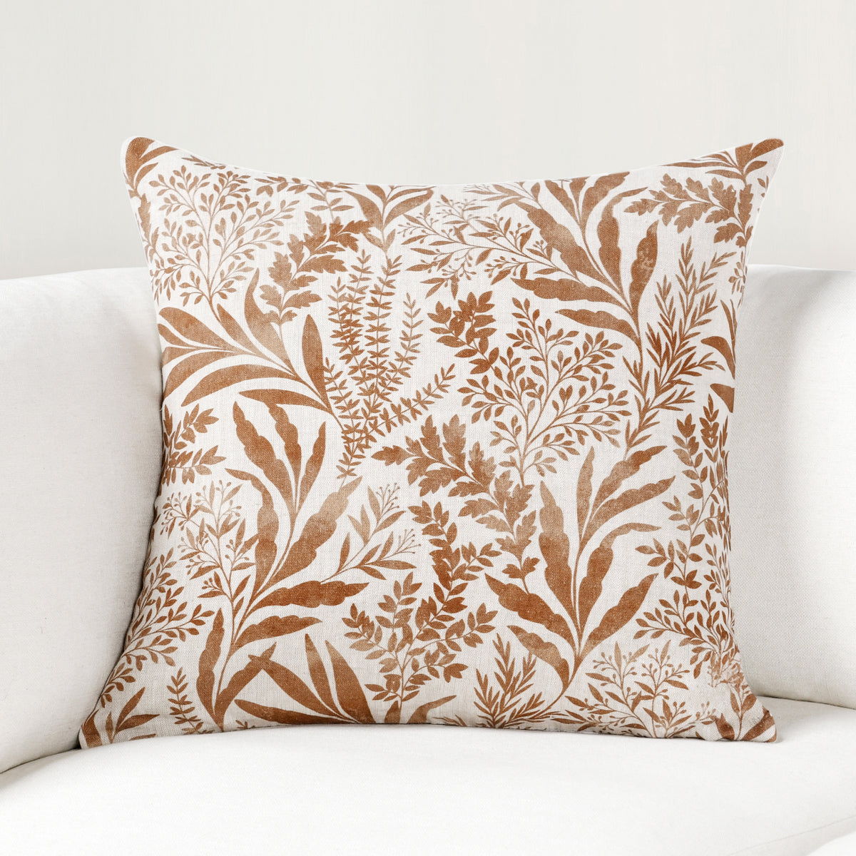 Rectangular pillow with tan and chestnut botanical leaf and branch print
