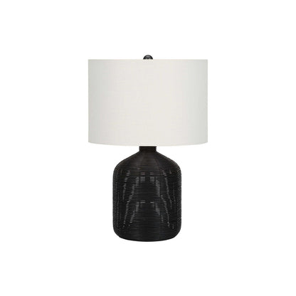 Modern table lamp with black rattan base and white fabric drum shade