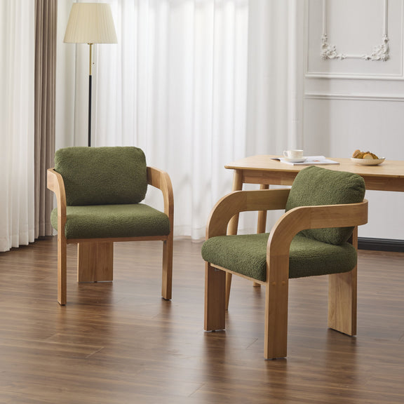 Pair of dark green cushioned dining chairs with curved wooden frames around a table