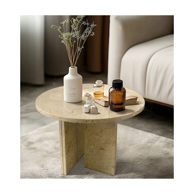 Round beige stone coffee table with veined top and angled pedestal base