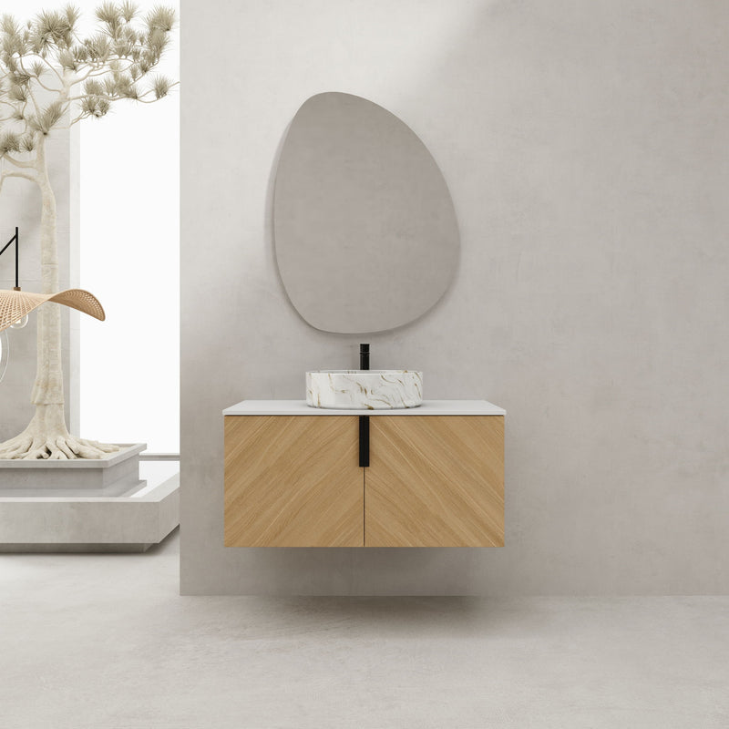 Wall-mounted bathroom vanity with light wood doors, white countertop, and white vessel sink