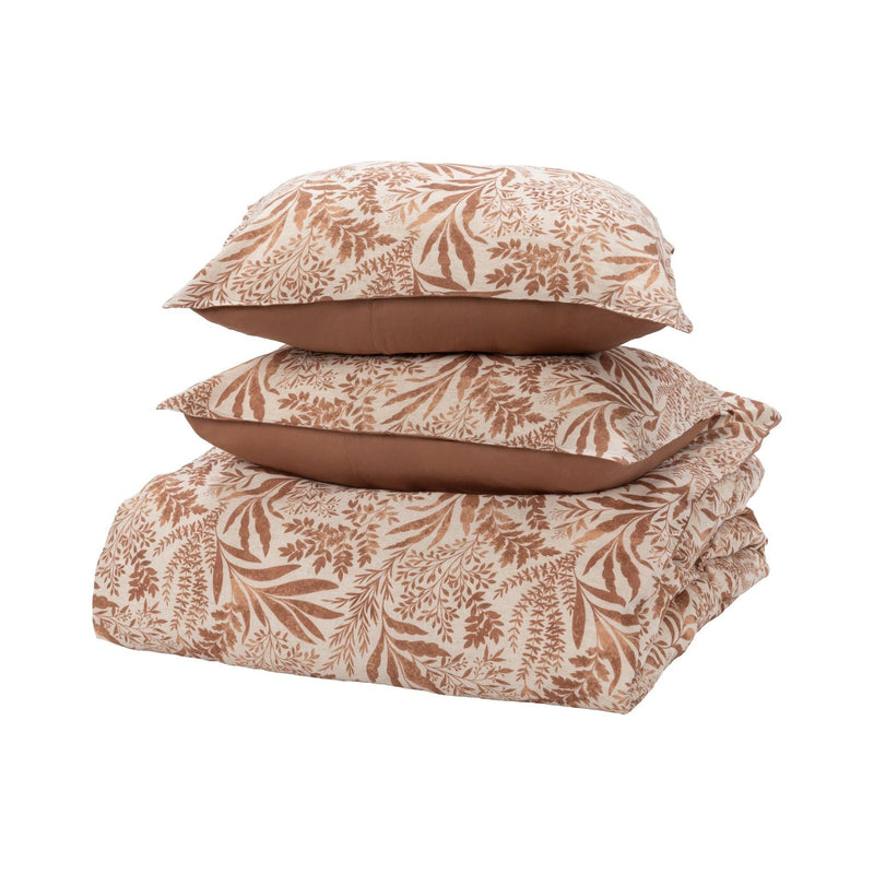 Chestnut orange leaf-pattern duvet and pillowcases stacked with brown backing