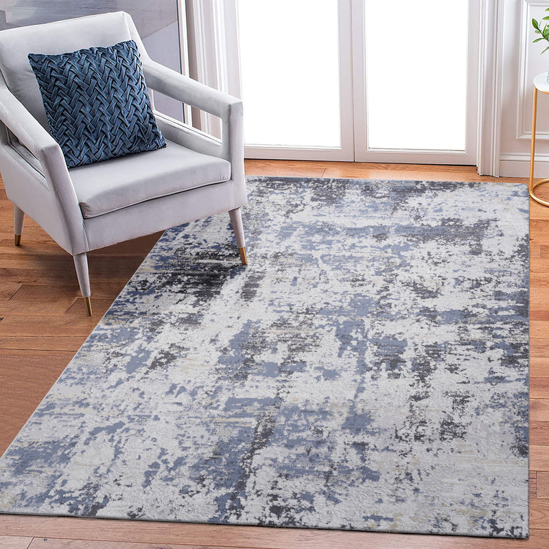Abstract area rug with blue-gray distressed design, clean rectangular edges