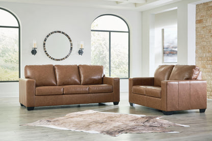 Brown upholstered sofa and matching loveseat with tufted back cushions