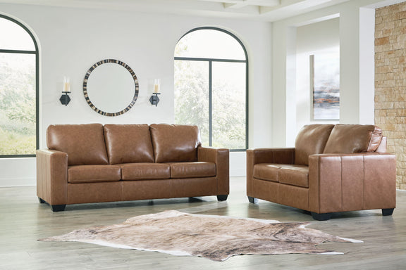 Brown upholstered sofa and matching loveseat with tufted back cushions