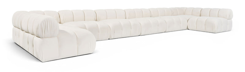 White modular sectional sofa with padded chaise and corner modules