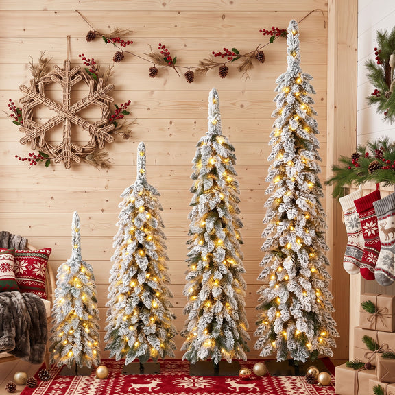 Four slim green Christmas trees with snow-dusted branches and warm LED lights