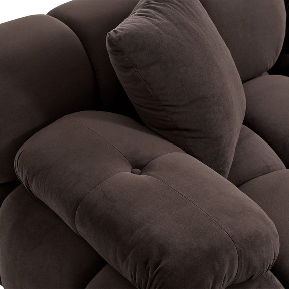 Brown loveseat seat cushion with visible seam and soft fabric texture, plus matching throw pillow