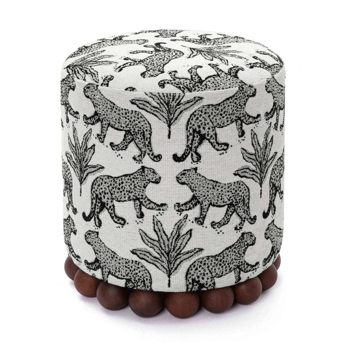 Gray cylindrical ottoman with black-and-white animal print and dark wood ball base.