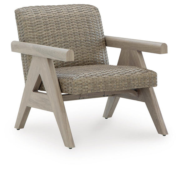 Beige woven rocking lounge chair with wide arms and light-wood legs