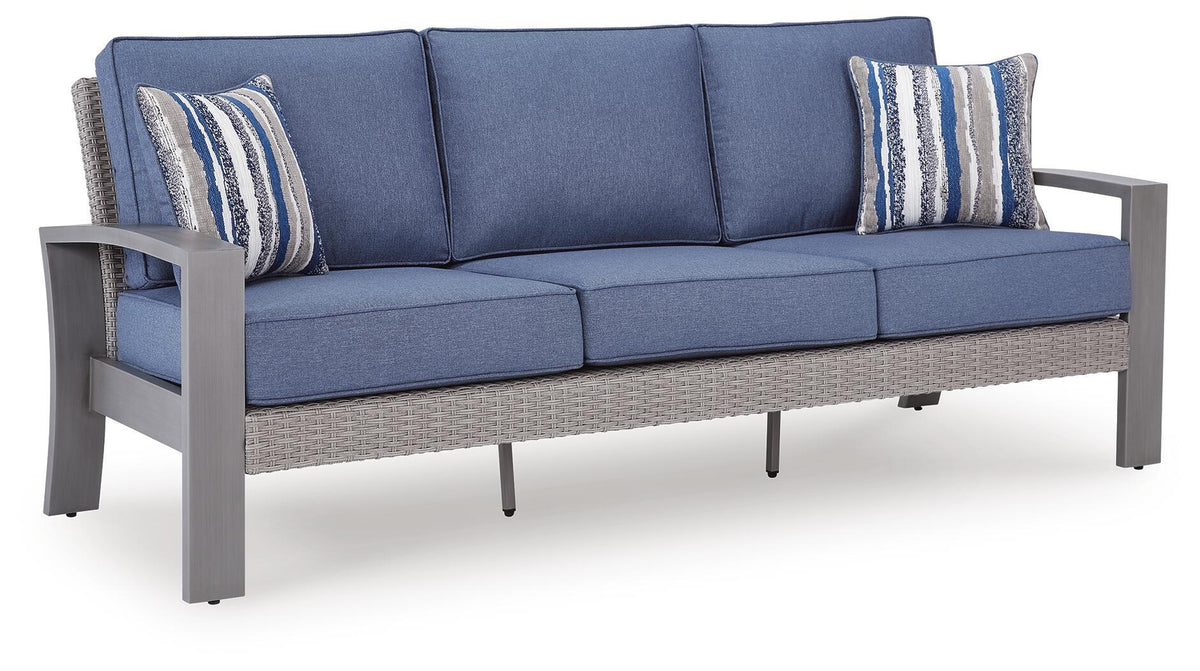 Blue-gray sofa with cushions and two striped pillows, armrests visible