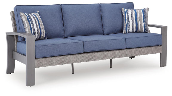 Blue-gray sofa with cushions and two striped pillows, armrests visible