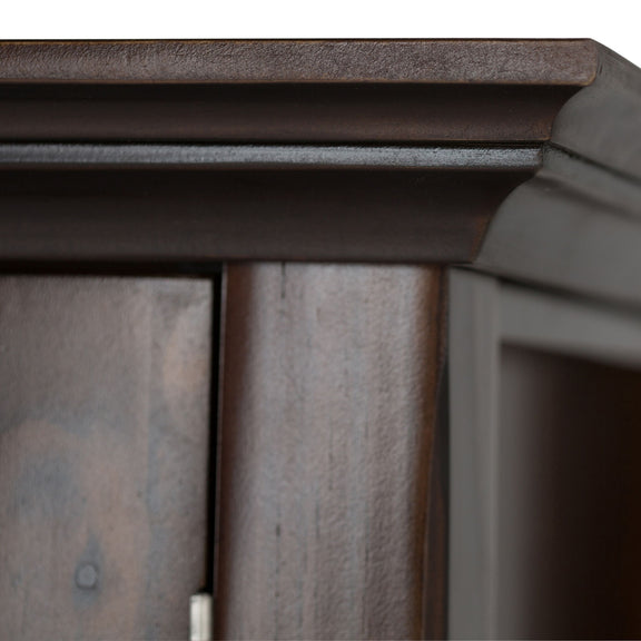 Brunette brown cabinet corner and top trim with visible wood paneling