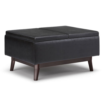 Upholstered storage ottoman coffee table with hinged top, dark upholstery and tapered legs