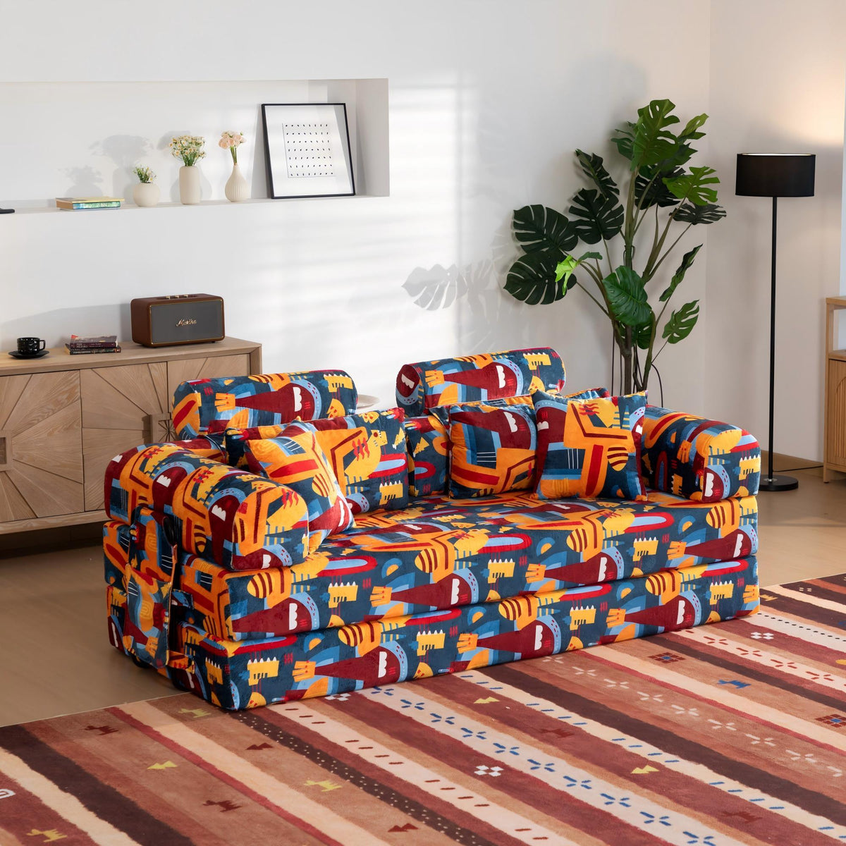 Convertible sofa bed with city-style print upholstery and two padded armrest sections