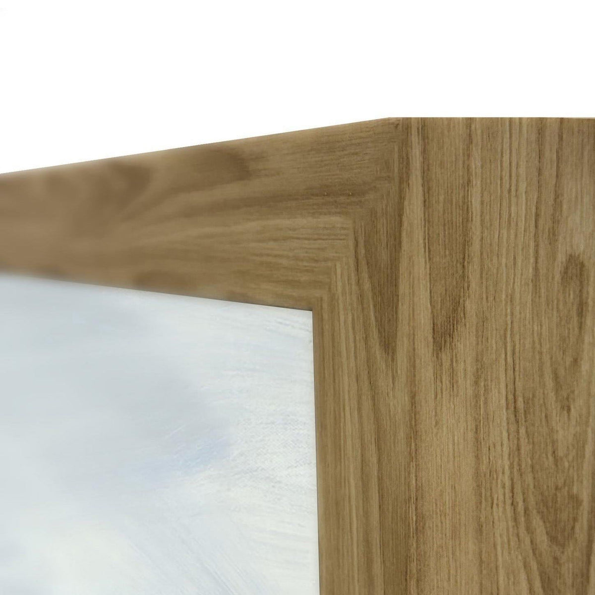 Wood frame corner detail on a light blue abstract painting