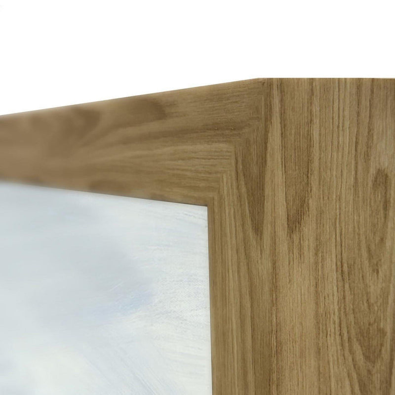 Wood frame corner detail on a light blue abstract painting