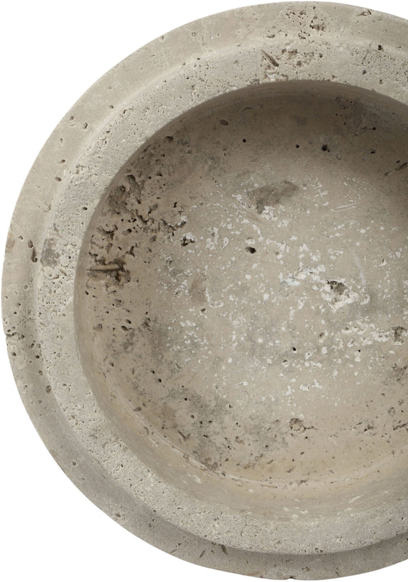 Close-up of light travertine bowl exterior with mottled beige speckles