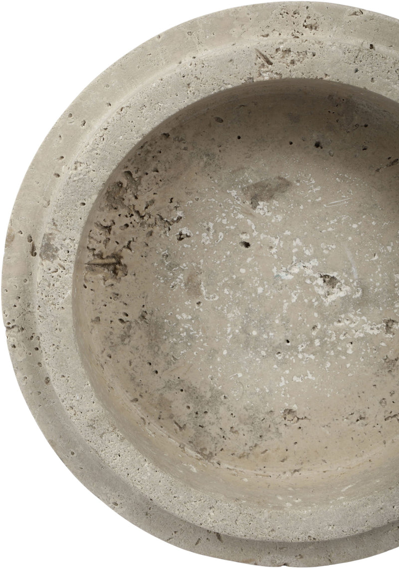 Close-up of light travertine bowl exterior with mottled beige speckles