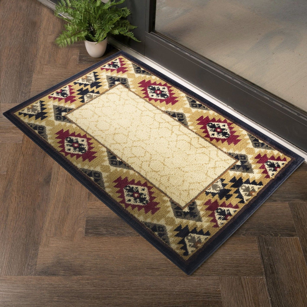 Beige southwest area rug with geometric border in black, maroon, and tan