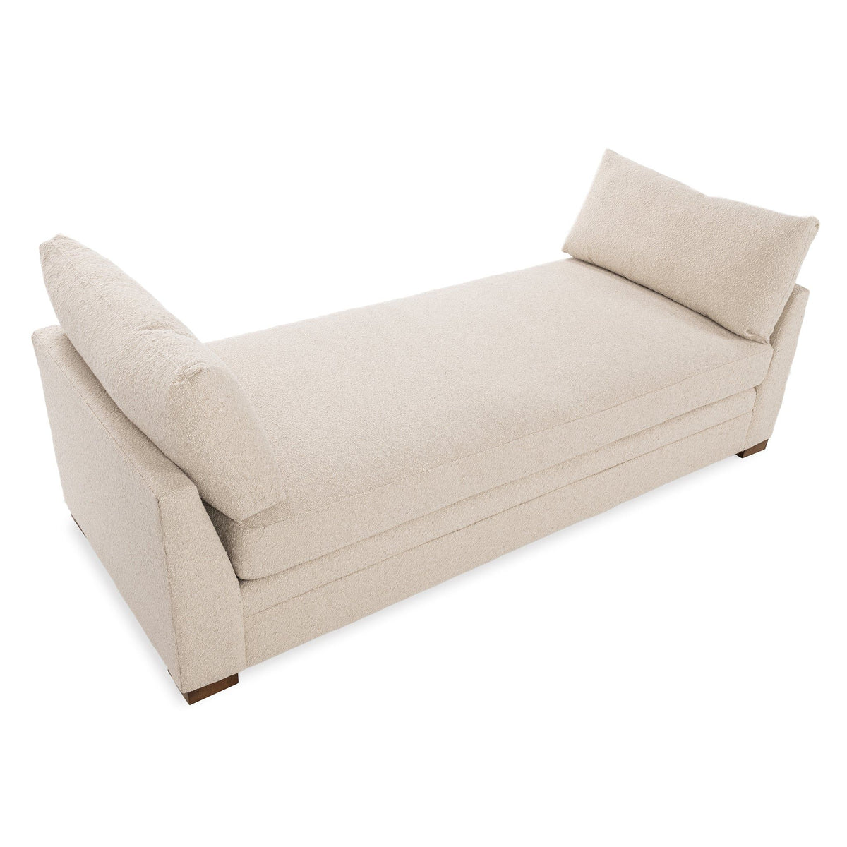 Upholstered daybed with two back cushions, light beige fabric, chaise angle, wooden legs