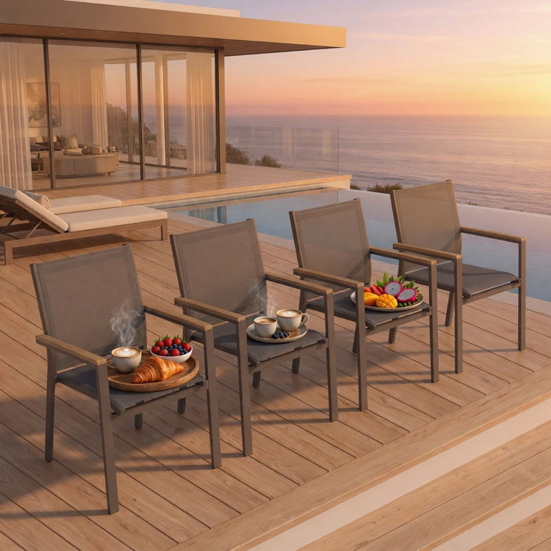 Dark gray outdoor lounge chairs with woven backrests and wood-toned armrest bars on deck