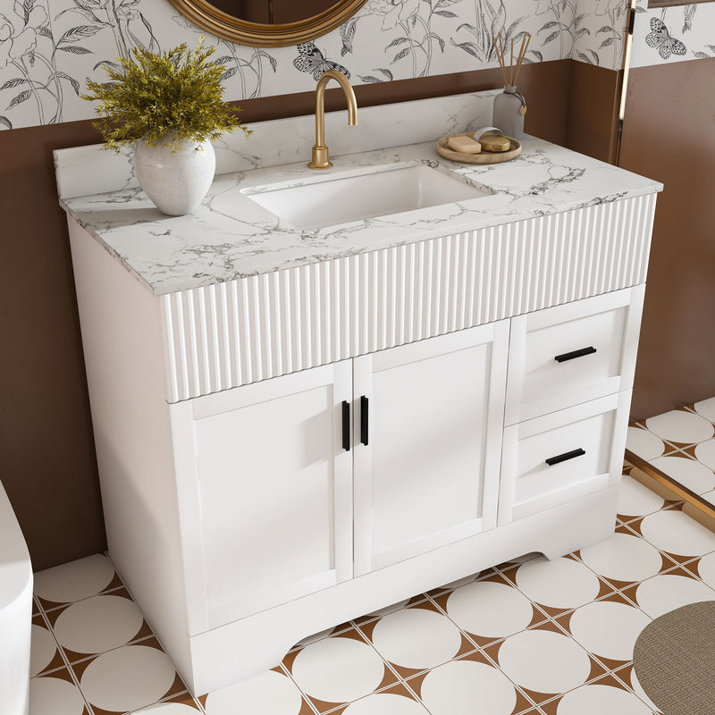 White fluted bathroom vanity set with integrated sink and drawers, shown in a bathroom corner