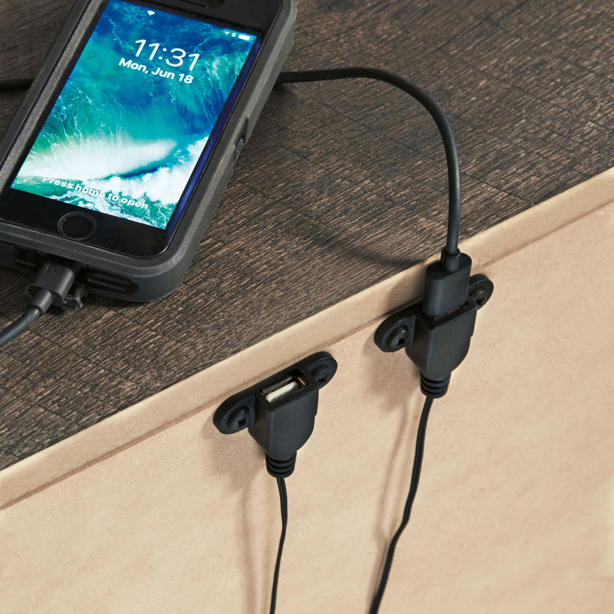 Gray night stand top with two drawers; bar pulls visible with phone charging cable