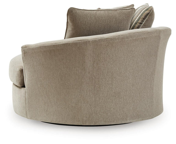 Oversized swivel accent chair, light beige upholstery with striped throw pillow