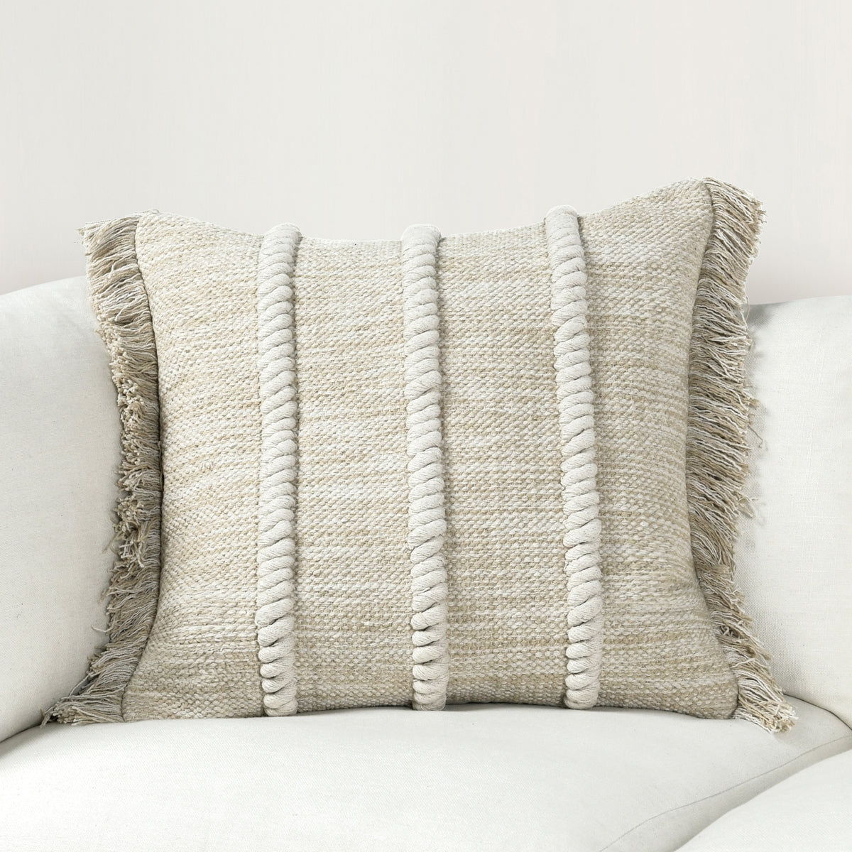 Natural fabric lumbar pillow with vertical stripe texture and fringe trim
