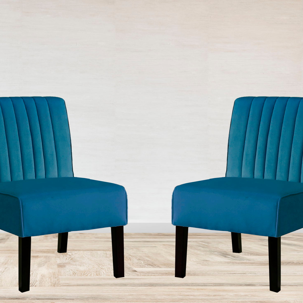 Pair of blue upholstered accent chairs with vertical tufted backs and wide arms, black legs.