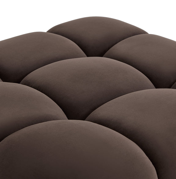 Dark brown sectional upholstery close-up showing thick, scalloped cushion padding