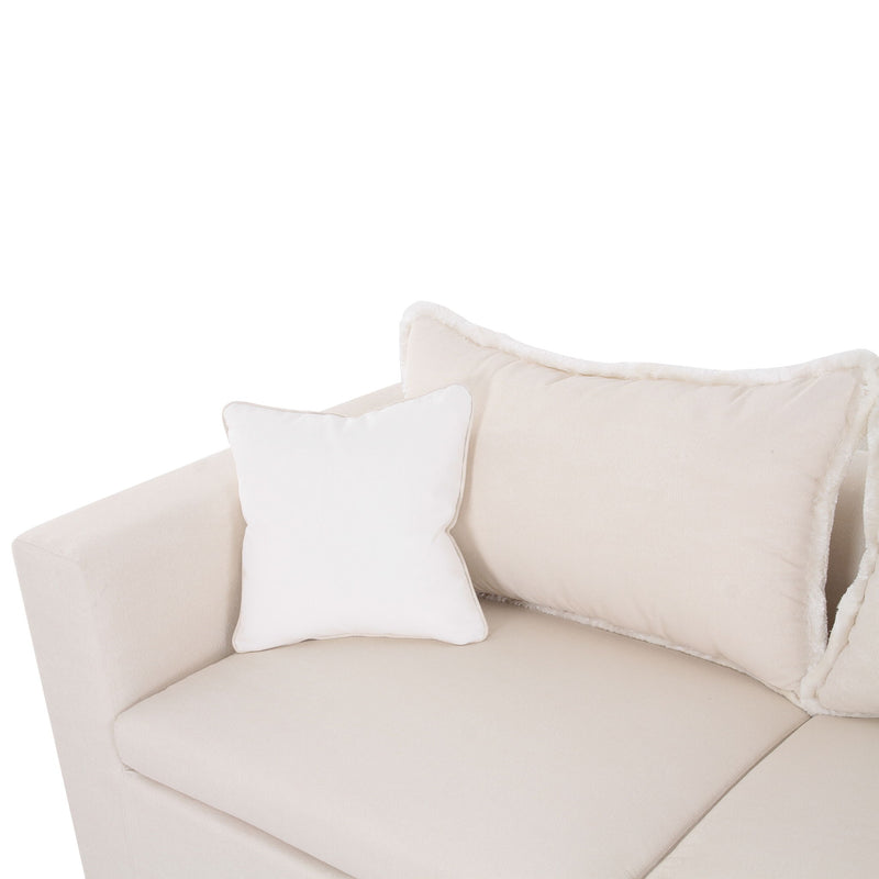 Corner view of cream-white boucle outdoor sofa with large back cushion and throw pillows